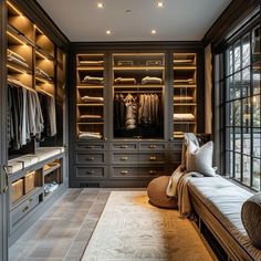 a large walk in closet with lots of drawers