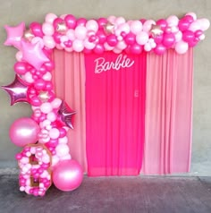 a balloon arch with pink and white balloons