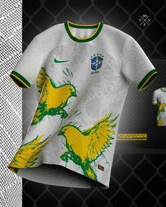 an image of a shirt with yellow and green birds on it in front of a chain link fence