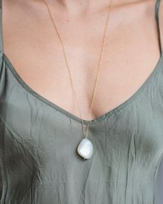 Featuring a large Ceylon Moonstone pebble suspended on a signature hammered gold-filled fringe pendant, this classic necklace celebrates simplicity.  Moonstone first appears white, then flashes bright rainbow or blue. Known as the light sister of Labradorite, it’s primarily found in Sri Lanka, India, and Madagascar, an Minimalist Long Drop White Necklace, Minimalist White Long Drop Necklace, Modern White Teardrop Necklace, Elegant Moonstone Necklace With Large Stone, Elegant White Necklace With Large Stone, Elegant White Necklaces With Large Stone, Moss Aquamarine, Bright Rainbow, White Moonstone