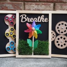 three wooden frames with flowers and gears in them