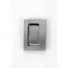 a square metal object on a white wall