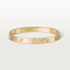 Cartier - LOVE bracelet - Bracelet Gold/Gold - LOVE bracelet, 18K yellow gold (750/1000). Comes with a screwdriver. Width: 6.1 mm. Created in New York in 1969, the LOVE bracelet is an icon of jewelry design: a close fitting, oval bracelet composed of two rigid arcs which is worn on the wrist and removed using a specific screwdriver. The closure is designed with two functional screws placed on either side of the bracelet: you will need help to open or close it. To determine the size of your LOVE Classic Cartier Bracelets For Wedding, Classic Cartier Bracelet Perfect For Gifts, Classic Cartier Bangle For Anniversary, Modern Cartier Gold Bracelet, Modern Cartier Round Bangle, Modern Cartier Gold Bangle Bracelet, Classic Cartier Gold Bangle Bracelet, Classic Cartier Jubilee Bracelet Bangle, Modern Cartier Bangle Bracelets