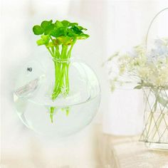 there is a vase with flowers in it on the wall next to a fish bowl