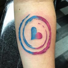 a colorful tattoo on the leg of a person with a heart and letter in it