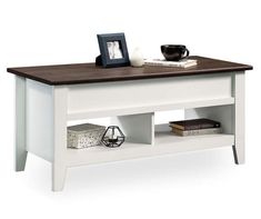 a white coffee table with two shelves and a book shelf on the bottom one side