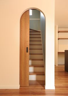 an open door leading to a room with stairs