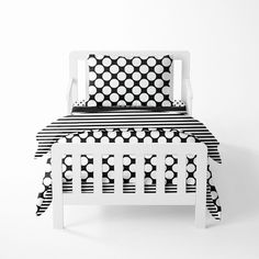 a bed with black and white designs on it