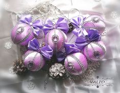 a bouquet of pink and silver ornaments with purple bows