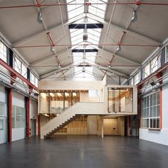 the inside of an empty building with stairs and windows