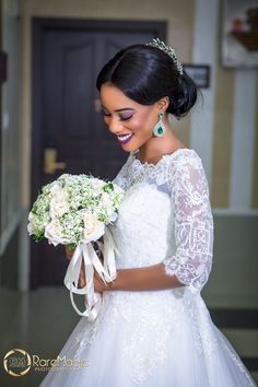 a woman in a wedding dress holding a bouquet