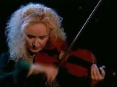 a woman with blonde hair playing the violin