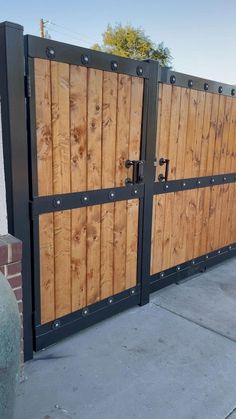 a large wooden gate with metal bars on it