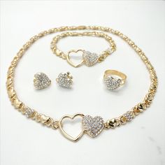 "18k Gold Filled Cubic Zirconia Double Hearts with XoXo Hug and Kisses Shape Set - Set Size: Necklace and Bracelet Thickness: 6mm | Necklace and Bracelet Heart Width: 22mm | Ring Size: 9 | Ring Width: 14mm | Earrings Height: 15mm | Earrings Width: 16mm | Necklace Length: 18 inches | Bracelet Length: 8 inches 💎 With new products daily, quality and competitive prices, in DiJu Jewelry you find the most unique styles of modern designs, always looking for elegance and market trends. *Helping your Je Valentine's Day Gold Rhinestone Jewelry, Gold Cubic Zirconia Jewelry Set For Valentine's Day, Gold Heart-shaped Jewelry Sets For Party, Heart-shaped Gold Jewelry Sets For Parties, Gold Jewelry Sets For Valentine's Day, Gold Rhinestone Jewelry Sets For Anniversary, Bracelet Heart, Market Trends, Solid Gold Jewelry