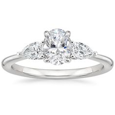 a white gold engagement ring with an oval cut diamond in the center and pave set shoulders