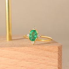 Gold Vintage Emerald Ring Oval Cut Green Gemstone Ring 14k Real Solid Gold Unique Design Statement & Anniversary Rings for Women with Yellow Rose White Gold Options ➤ Ring Details * 14k / 18k Yellow Gold  * Gold Color Options; 14K / 18k White, Yellow, Rose Gold * Band Width: 1.35 mm * Thickness: 1.35 mm ➤ Gem Details * Gemstone 1 : Emerald * Gem width: 5 millimeter * Gem length: 7 millimeter * Cut Type: Oval * Gemstone 2 : Moissanite * Gem width: 1.5x1.5 millimeter * Cut Type: Round * Ready to S Wedding Emerald Ring In Oval Cabochon Shape, Wedding Emerald Ring With Oval Cabochon, Heirloom Oval Emerald Ring Birthstone, Heirloom Oval Emerald Birthstone Ring, Oval Cluster Ring With Gemstone Accents, Oval Emerald Gemstone Ring Fine Jewelry, Marquise Gemstone Ring For Proposal, Oval Emerald Ring In 14k Gold For Proposal, Oval Yellow Gold Cluster Ring With Gemstone Accents