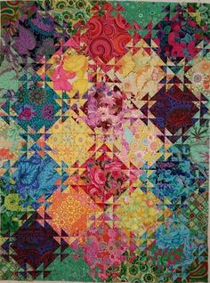 a multicolored quilt with many different designs on it's edges and sides