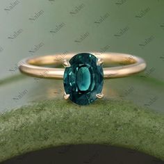 an oval cut green tourmaline ring with gold band