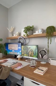 a person sitting at a desk with two computer monitors