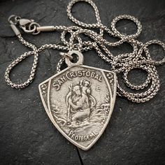 This St. Christopher medal was cast from our vintage original that surfaced in South America. This is truly a unique medal. St. Christopher is known as the patron saint of travelers. St. Christopher provides protection and peace, especially while on-the-go or transitioning to a new phase in life.
The necklace is available in 20 to 24 inches in length and looks great in an open collared shirt or over a t-shirt.
Pendant Material: Pewter Necklace Material: Stainless Steel Necklace Clasp: Lobster Ne Lobster Necklace, Masculine Jewelry, St Christopher Medal, Mens Cross Necklace, Edgy Jewelry, St Christopher, Catholic Jewelry, Mens Silver Necklace, Jewelry Chain