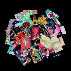 a pile of assorted stickers sitting on top of each other in front of a black background