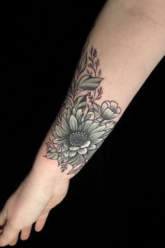 a woman's foot with a flower tattoo on it