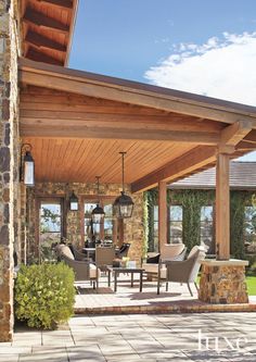 a covered patio with chairs and tables on it