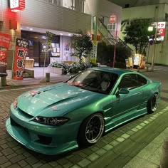 a green car parked in front of a building