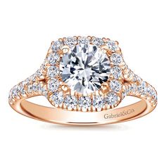 a rose gold engagement ring with an oval center surrounded by round diamonds