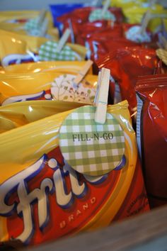 many bags of chips are lined up on the table