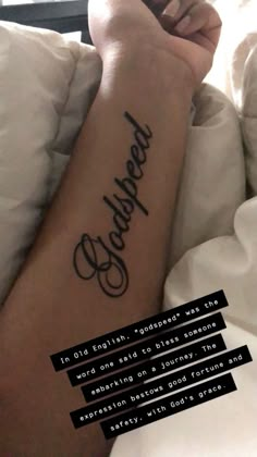 a person laying in bed with a tattoo on their arm and the words beneath them