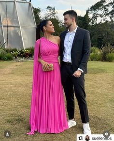 a man and woman in formal wear standing next to each other