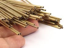 there are many gold colored straws in the palm of a person's hand