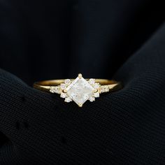 a close up of a diamond ring on a black cloth