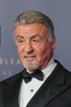 an older man in a tuxedo and bow tie