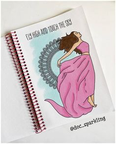 a spiral notebook with an illustration of a woman wrapped in a pink blanket on it