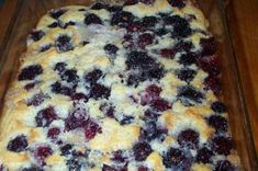 a pan filled with blueberry cobble sitting on top of a wooden table