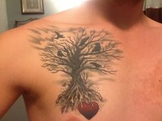 a man with a tree tattoo on his chest holding a red heart and two birds