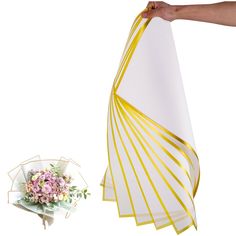 a bouquet of flowers sitting on top of a table next to a white and yellow umbrella