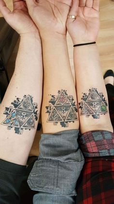 two people with matching tattoos on their arms