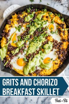 a skillet filled with eggs, meat and avocado on top of a marble counter