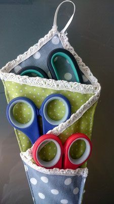 three pairs of scissors are in a holder