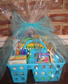 a blue basket filled with lots of school supplies