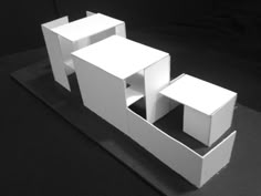 a white sculpture sitting on top of a black surface