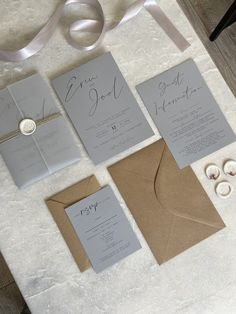 the wedding stationery is laid out on the table