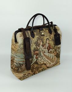 Welcome to AliDesignStore This weekender bag made of Needle Point gobelin Tapestry with supple cow leather. Suede-like interior. Material.Cotton Threads:100% Cotton Measurements ; 50 cm x 44 cm x 19 cm  /   19.6''x17,5''x7.5'' Handle drop height : 12cm  /  4.7'' Adjustable Shoulder Strap - Handcrafted - Materials : Needle Point Gobelin Tapestry                       Supple Cow Leather                       Brass Accessories                       Suede-like interior - Ships from a small business Rectangular Tapestry Satchel For Travel, Luxury Handmade Travel Bag, Travel Tapestry Satchel Tote, Tapestry Tote Satchel For Travel, Travel Tapestry Tote Satchel, Travel Satchel With Top Carry Handle And Tapestry, Travel Satchel With Tapestry And Leather Handles, Travel Tapestry Shoulder Bag, Top Handle Tapestry Travel Bag