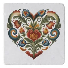 an ornate tile with flowers and leaves on white background, in the shape of a heart