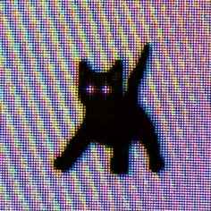 a black cat sitting on top of a tv screen