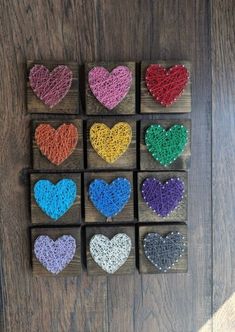 crocheted hearts are arranged on wooden blocks