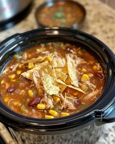 a crock pot filled with chicken tortilla soup